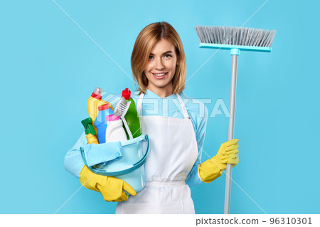 woman in gloves holding bucket of detergents and broom woman in gloves holding bucket of detergents and broom 96310301