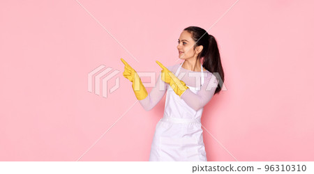 woman in rubber gloves pointing fingers aside at copyspace woman in rubber gloves pointing fingers aside at copyspace 96310310