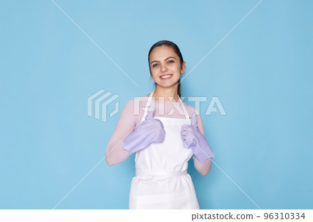 woman in gloves and cleaner apron showing ok sign woman in gloves and cleaner apron showing ok sign 96310334
