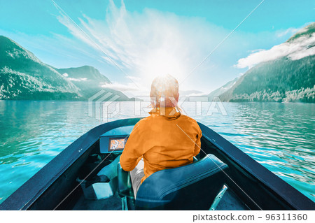Boat people. Young woman driving motor boat in nature 96311360