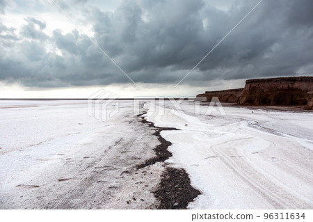Salt lake surface under grey cloudy epic sky 96311634