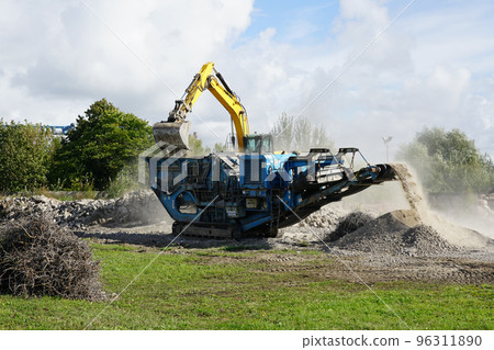 Mobile concrete and reinforced concrete construction debris shredding machine in operation 96311890