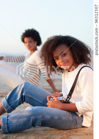 Pretty girl with old-fashioned camera 96312507