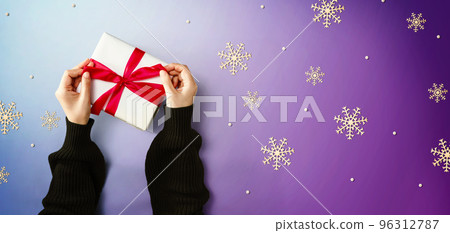 Person making a Christmas gift box Person making a Christmas gift box 96312787