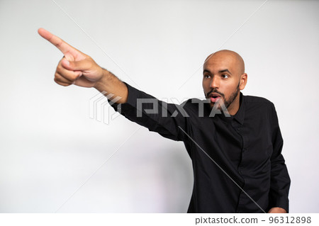 Portrait of amazed young man pointing finger at ad 96312898
