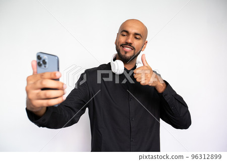 Portrait of happy young man taking selfie with mobile phone 96312899