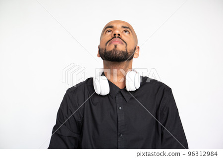 Successful young man in headphones making winning gesture 96312984