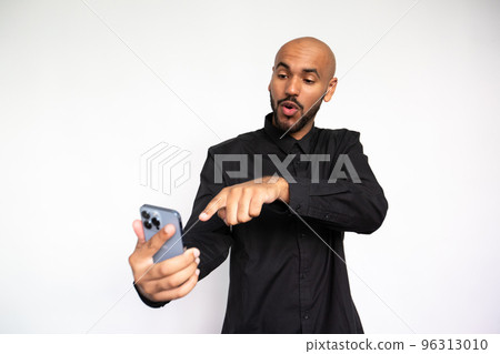 Portrait of excited young man poiting at mobile phone 96313010