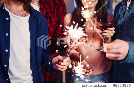 Group of friends having fun with sparklers. young people laugh. celebrating New Year together. Group of friends having fun with sparklers. young people laugh. celebrating New Year together. 96313950