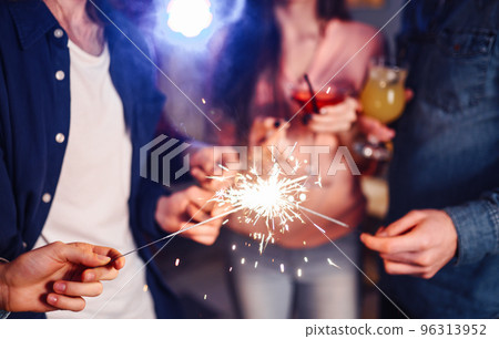 Group of friends having fun with sparklers. young people laugh. celebrating New Year together. Group of friends having fun with sparklers. young people laugh. celebrating New Year together. 96313952