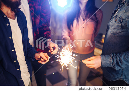 Group of friends having fun with sparklers. young people laugh. celebrating New Year together. Group of friends having fun with sparklers. young people laugh. celebrating New Year together. 96313954