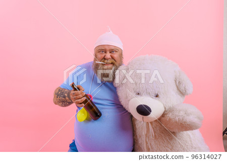 Fat happy man acts like a happy baby but drinks beer 96314027