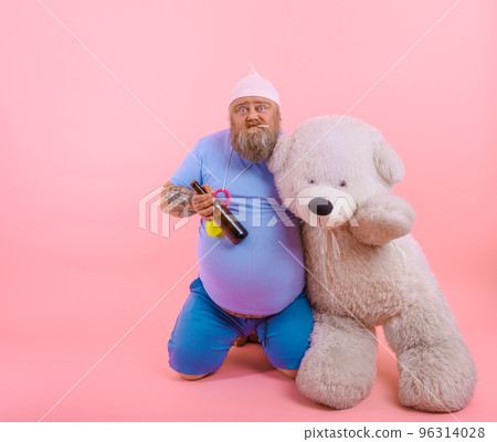 Fat thoughtful man acts like a thoughtful baby but drinks beer 96314028