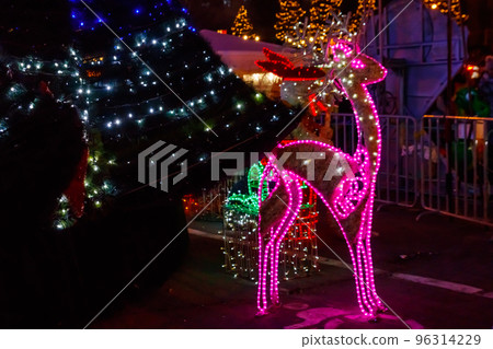 Illuminated Christmas deer at night. Decoration for Christmas and New Years holidays in a city park 96314229