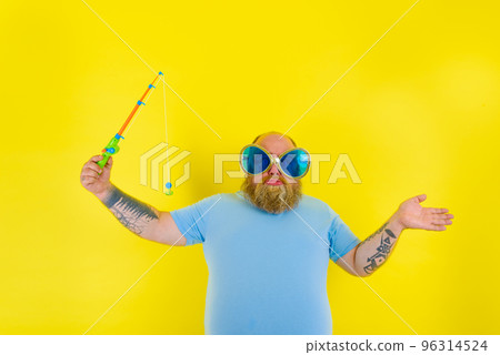 Fat man with beard and sunglasses is unhappy with the fishing rod 96314524