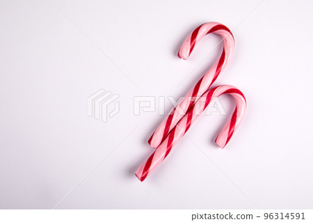 Two red candy canes on a white background Two red candy canes on a white background 96314591