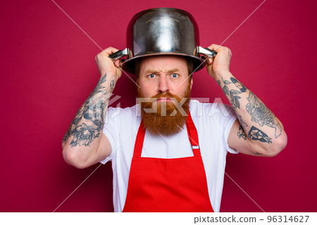 worried chef with beard and red apron plays with pot worried chef with beard and red apron plays with pot 96314627