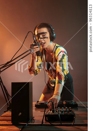 DJ woman using mixer turntables for musical performance, mixing techno music as dj performer. Cool artist adjusting volume and bass key on electronics stereo equipment, audio insturment. 96314813