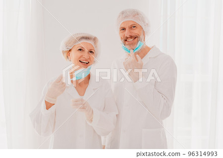 Smiling doctors with face mask are happy to work against covid-19 96314993