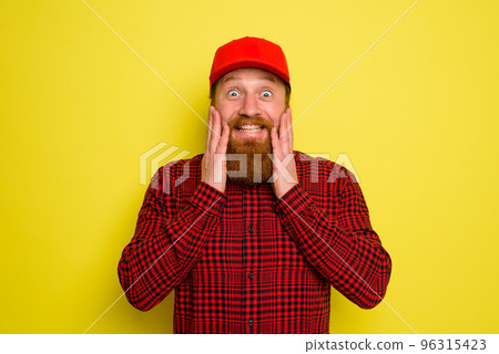 Delivery man with hat and beard has an happy expression Delivery man with hat and beard has an happy expression 96315423