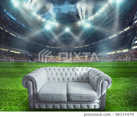 White sofa at the center of the soccer field 96315479