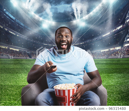 Viewer is located in the middle of the stadium sitting on his armchair Viewer is located in the middle of the stadium sitting on his armchair 96315480