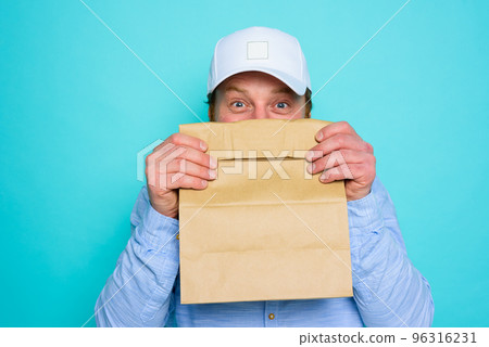 Delivery man hides his face with a food package Delivery man hides his face with a food package 96316231