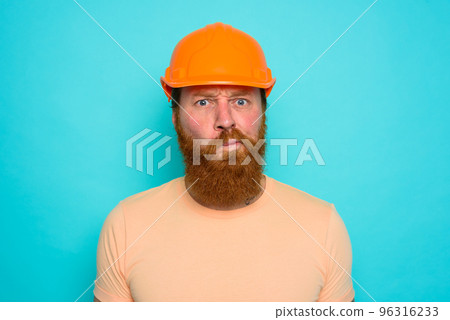 Worker with yellow hat is confused about his work Worker with yellow hat is confused about his work 96316233