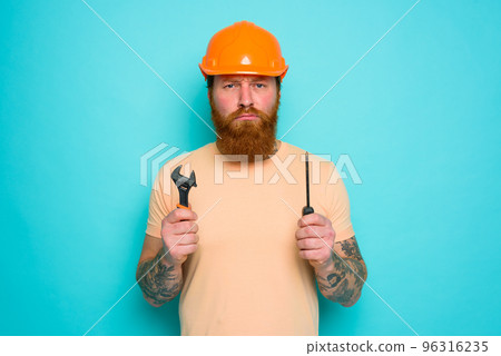 Worker with yellow hat is confused about his work Worker with yellow hat is confused about his work 96316235