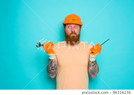 Worker with yellow hat is confused about his work Worker with yellow hat is confused about his work 96316236