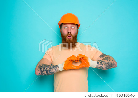 Worker with yellow hat is happy about his work 96316540