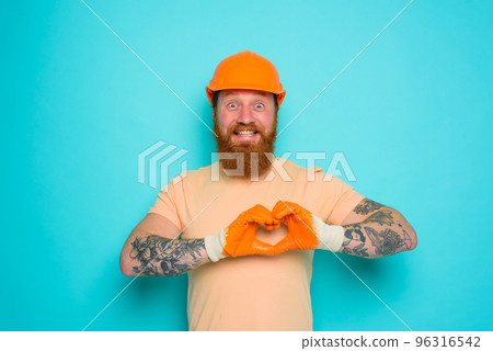 Worker with yellow hat is happy about his work 96316542
