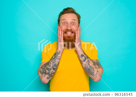 Man with yellow t-shirt and beard is very happy Man with yellow t-shirt and beard is very happy 96316545