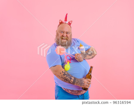 Fat happy man acts like a happy baby but drinks beer 96316594