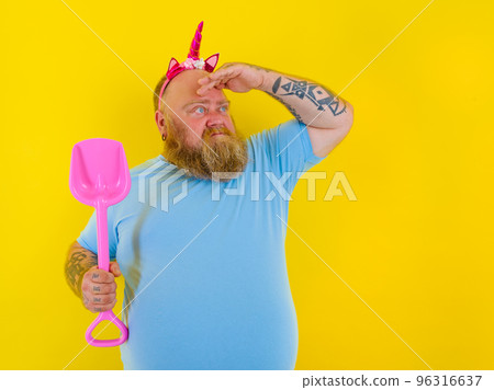 fat man with headband play with sea paddle 96316637