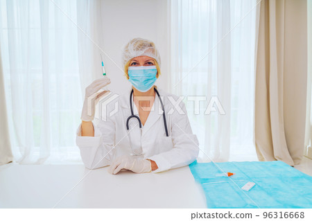 doctor with mask and syringe is ready to administer the vaccine against covid 19 doctor with mask and syringe is ready to administer the vaccine against covid 19 96316668