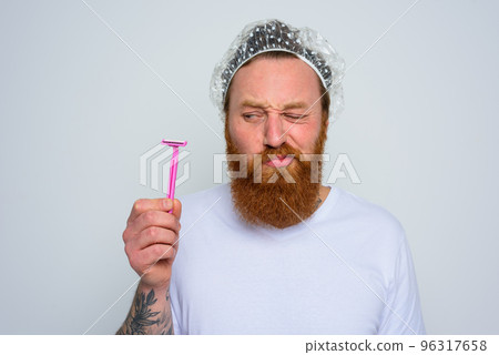 doubter man wants to adjust the beard with a razor blade 96317658
