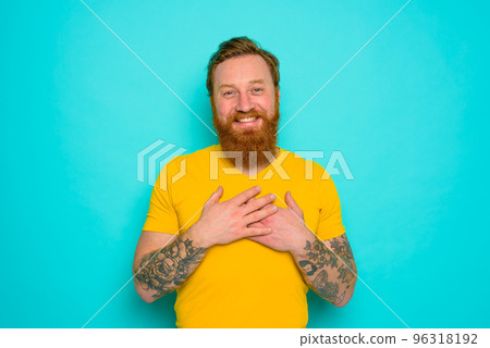 Man with yellow t-shirt and beard is very happy Man with yellow t-shirt and beard is very happy 96318192