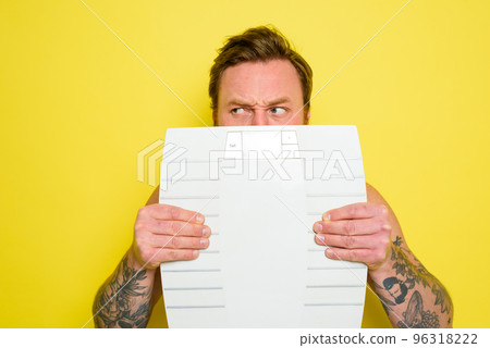 Dubious man with beard and tattoos is hidden behind the scales Dubious man with beard and tattoos is hidden behind the scales 96318222