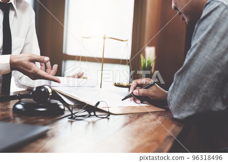 Discussing legal matters and signing important documents. 96318496