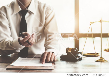 Reading the contract and signing the real estate purchase, the buyer is reading the important documents before entering into a building buy agreement with the agent. 96318508