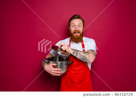 surprised chef with beard and red apron is ready to cook 96318729