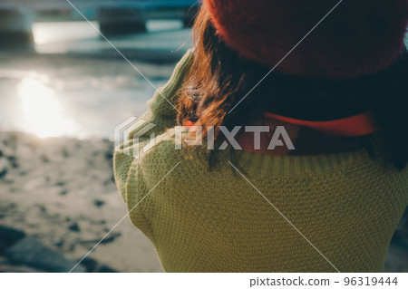 Photo of a young woman taking pictures with a camera on a riverbed Photo of a young woman taking pictures with a camera on a riverbed 96319444