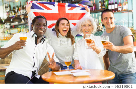 Diverse group celebrating with British flag 96319801