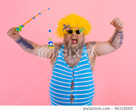 Fat happy man with beard and sunglasses have fun with the fishing pole 96320005