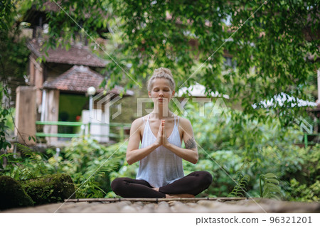 Girl practice yoga meditation outdoor in park 96321201