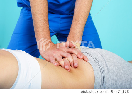 Girl performs exercises with a physiotherapist. Cyan background 96321378
