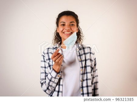 Woman removes the face mask. concept of pandemic of covid-19 coronavirus Woman removes the face mask. concept of pandemic of covid-19 coronavirus 96321385