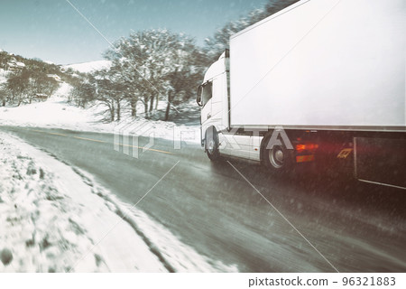 White modern truck moving fast in winter on a road with snow 96321883