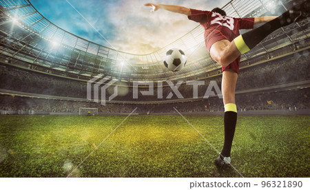 Football scene at the stadium with close up of a soccer shoe kicking the ball Football scene at the stadium with close up of a soccer shoe kicking the ball 96321890